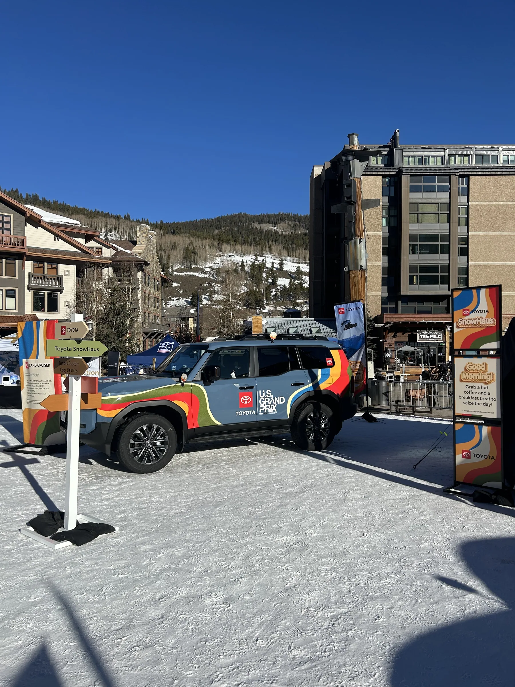 Graphic-wrapped Toyota parked among Toyota signage in the alpine village