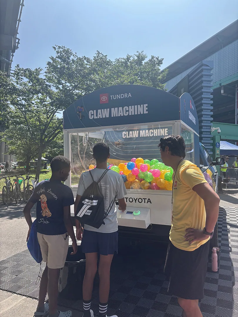 Guests playing the Toyota Tundra claw machine at the track activation