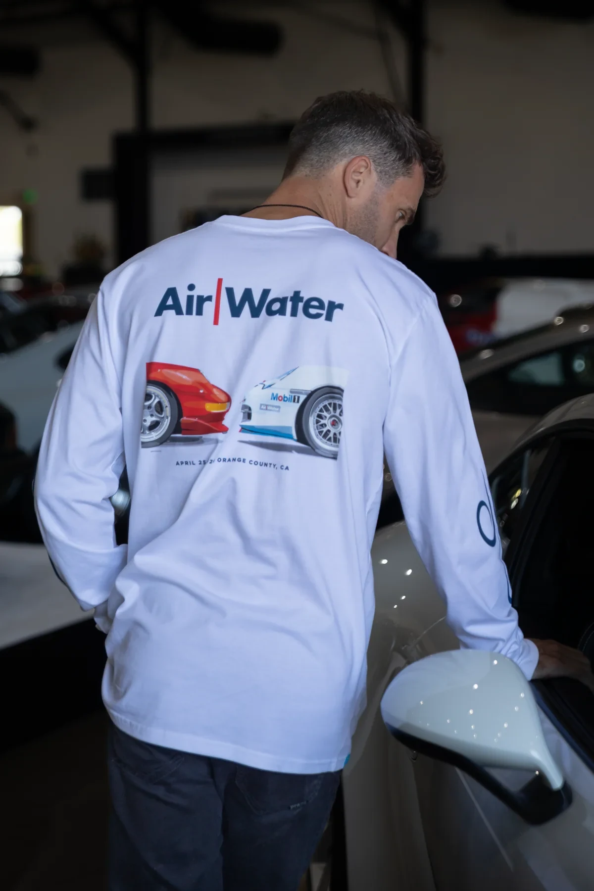 LUFT Air/Water long sleeve worn among parked Porsches