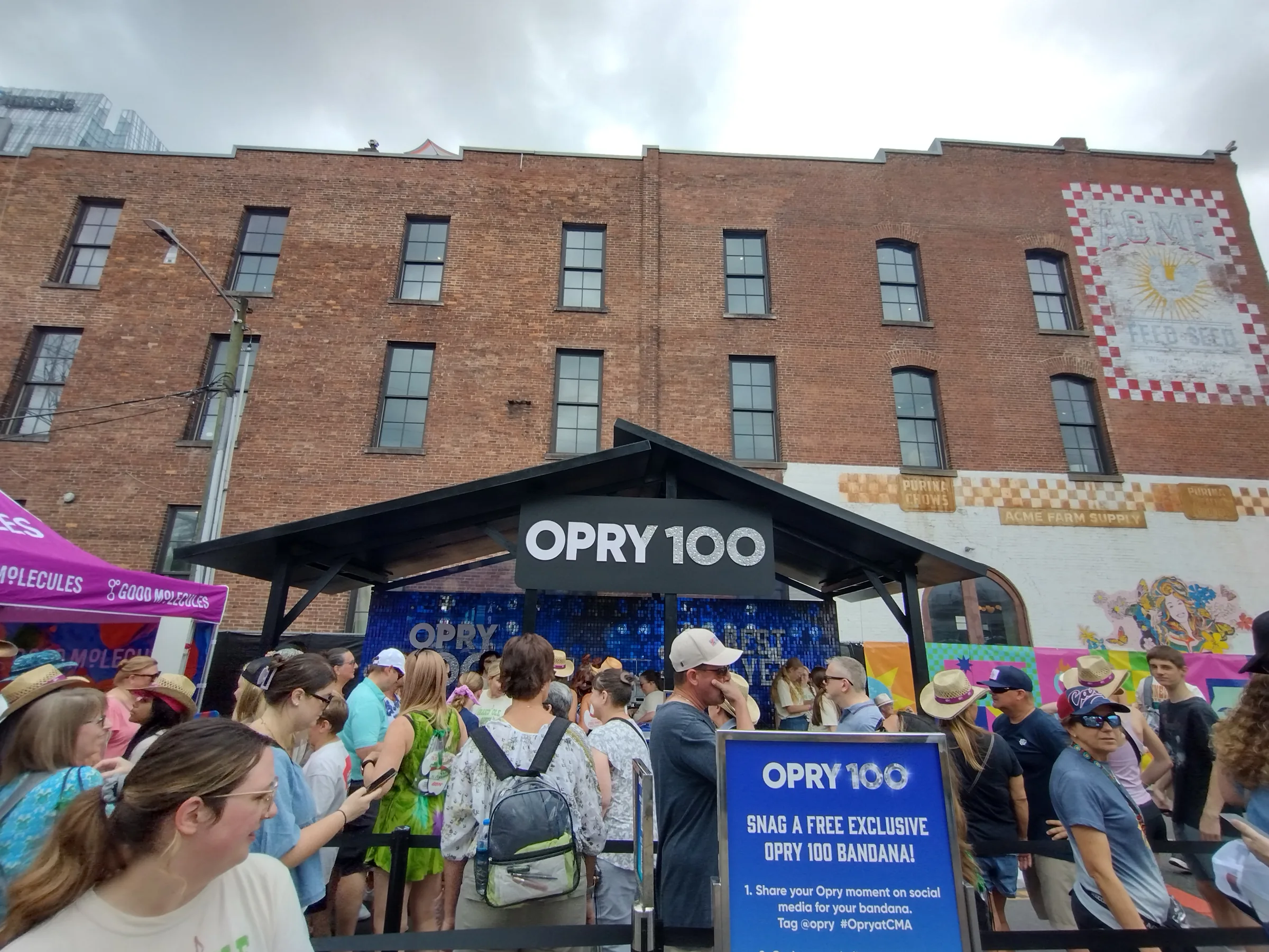 Guests queued through the Opry 100 activation beneath the centennial signage