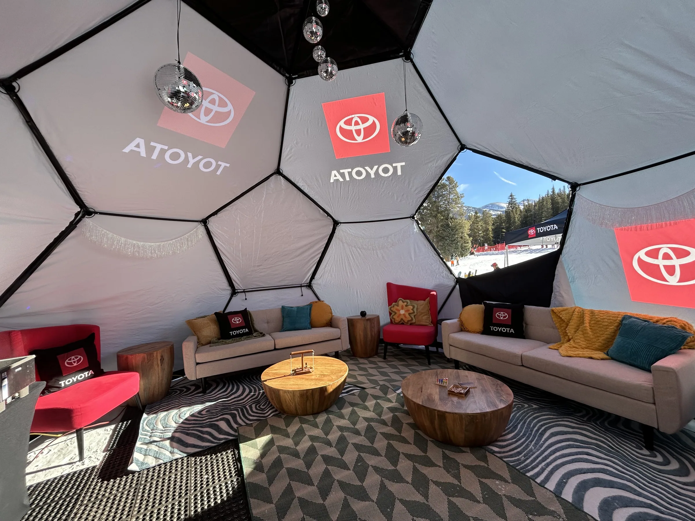 Interior of the Toyota geodesic dome lounge with branded panels and lounge seating