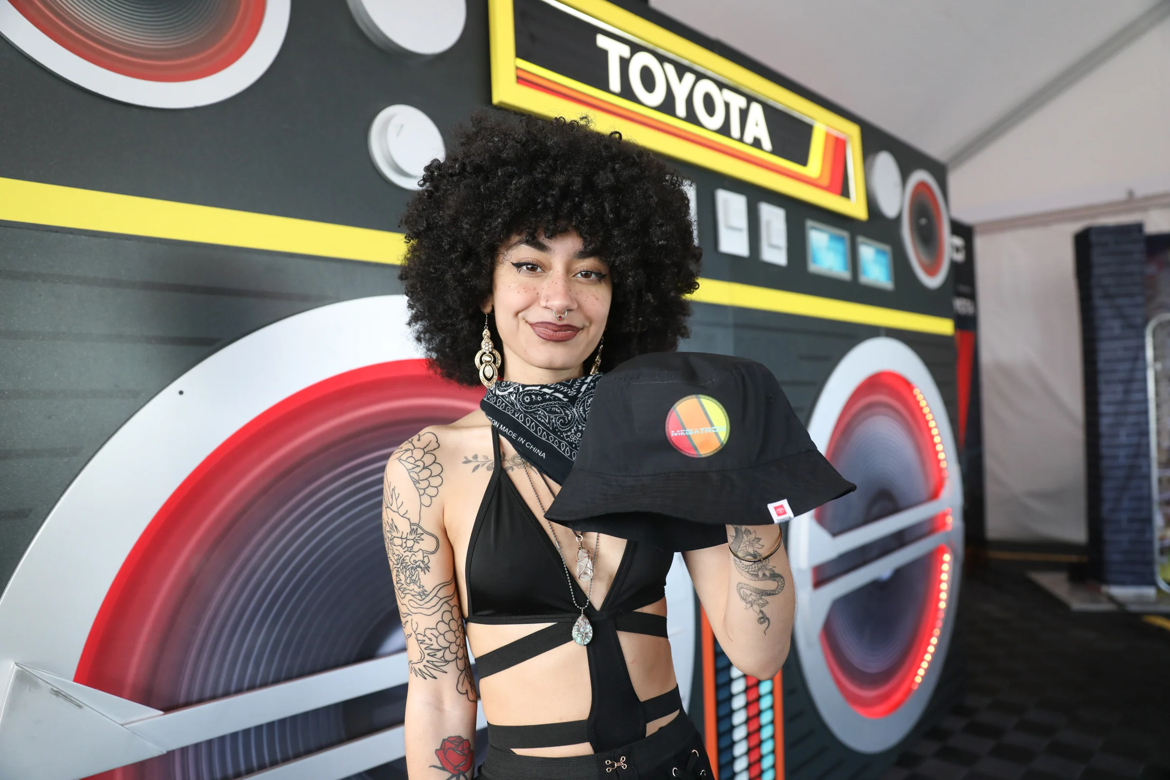 Portrait of a festival guest in front of the Toyota boombox stage build