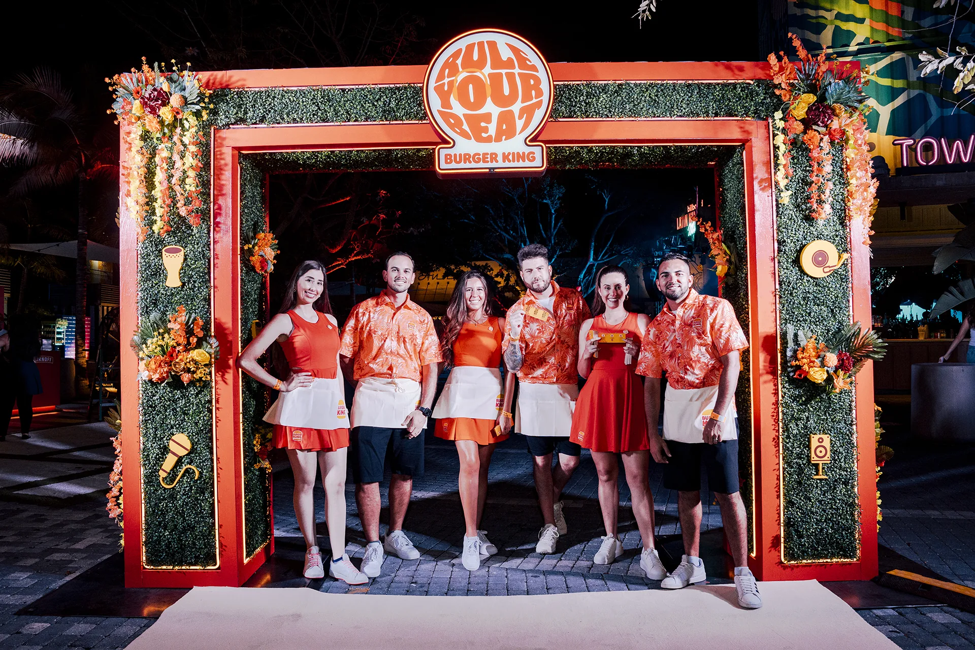 Illuminated Rule Your Beat arch framing guests entering the Burger King activation
