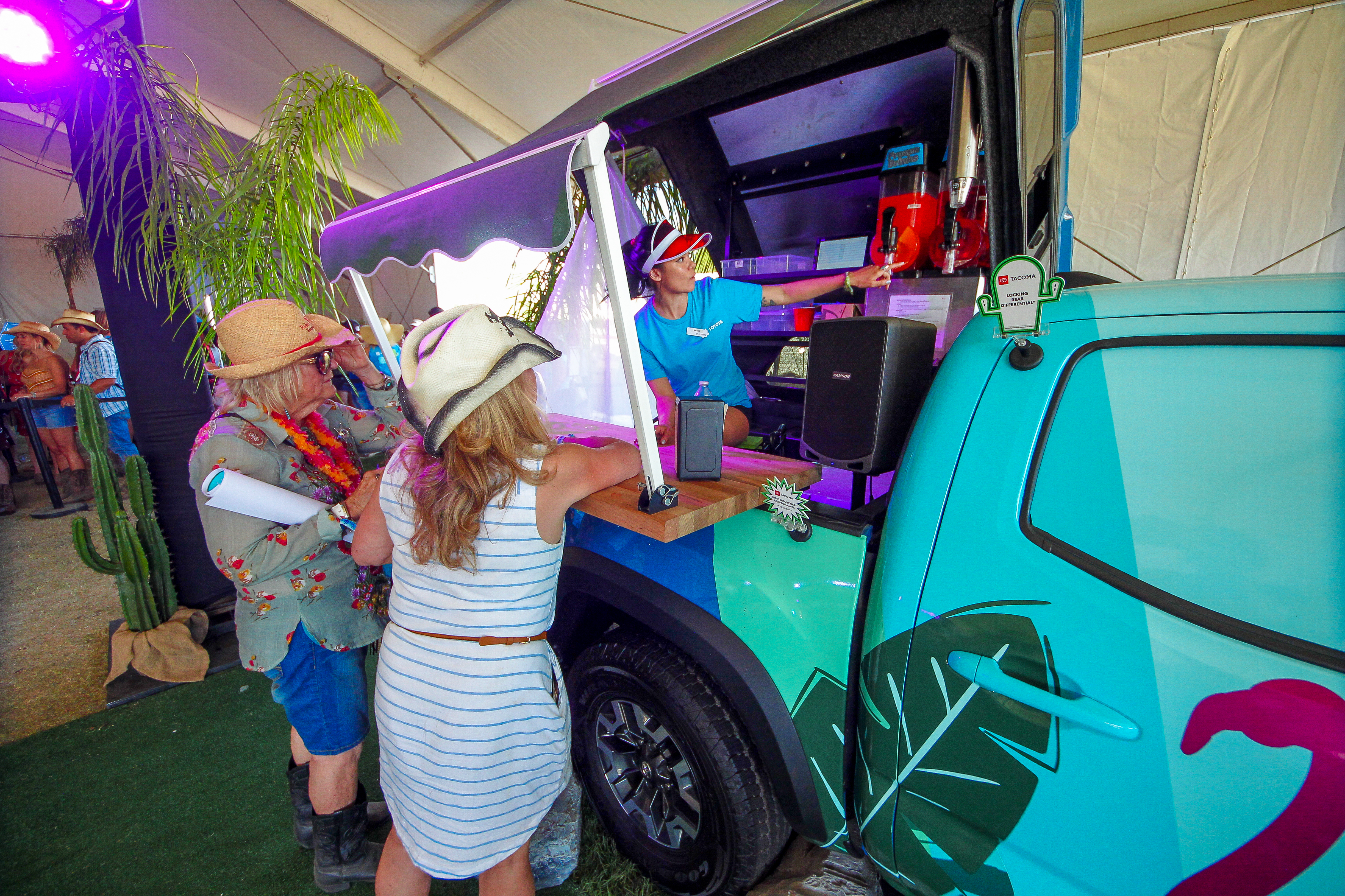 Guests gathered at the Paradise Park bar built around a Toyota Tacoma