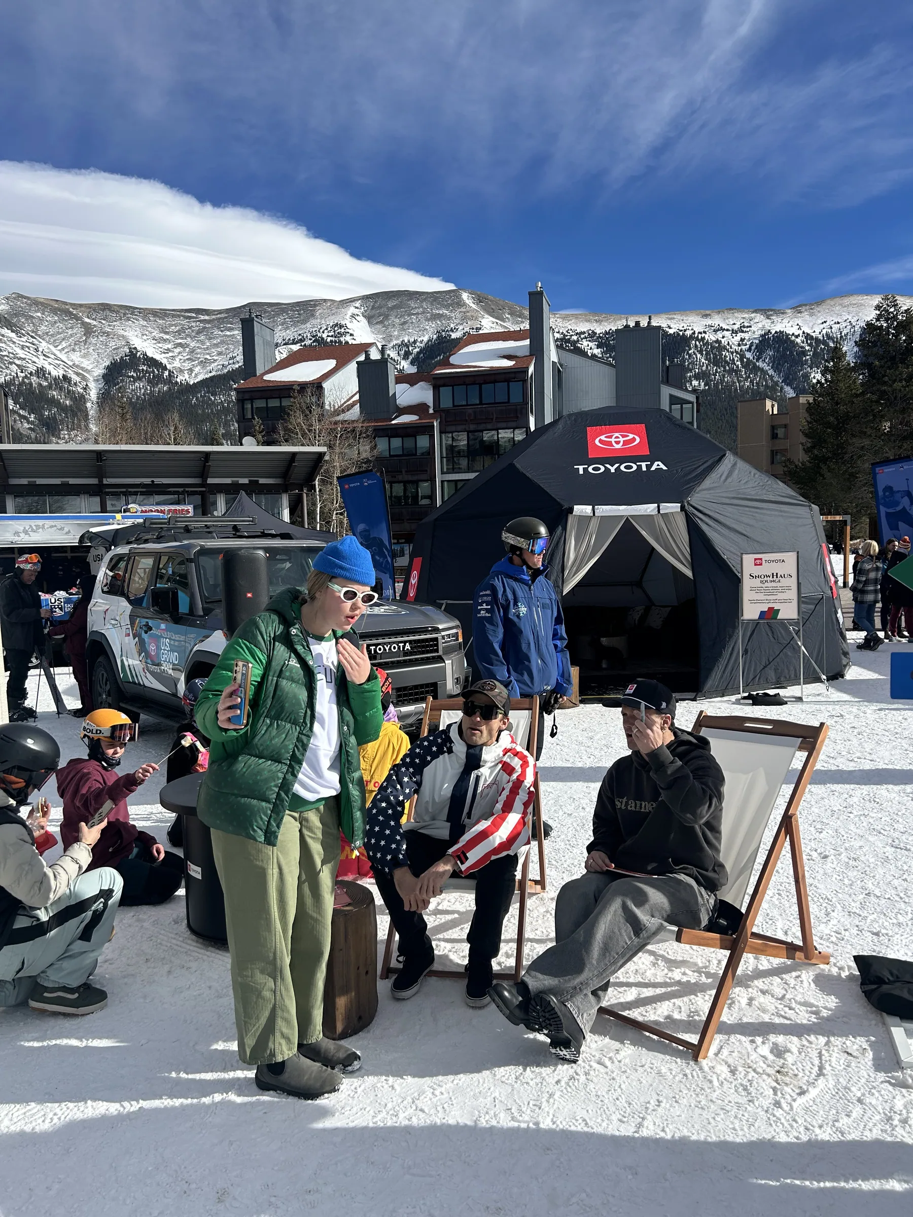 Guests seated in the Toyota mountainside lounge under branded canopies