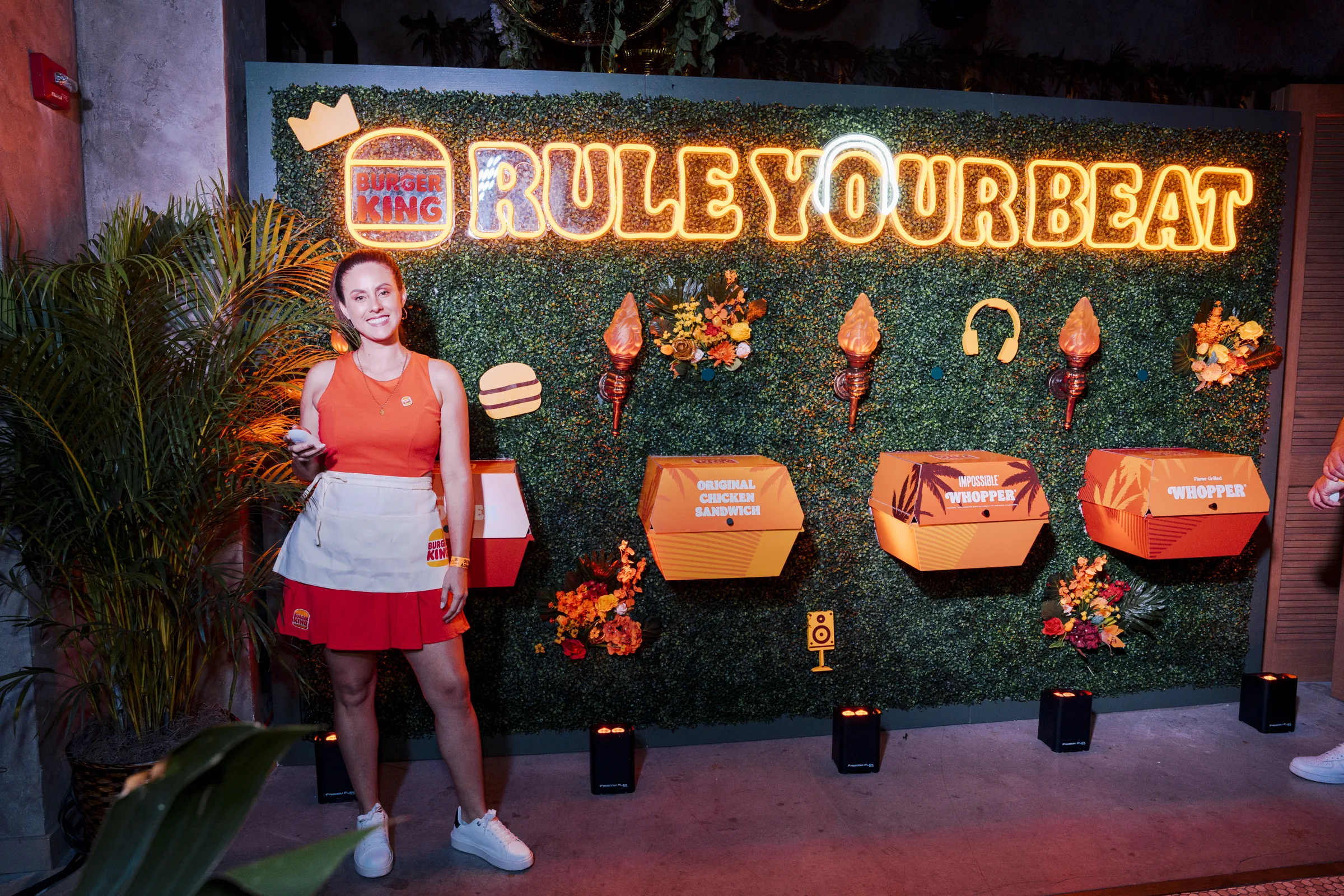 Rule Your Beat neon environmental wall glowing over the Burger King activation at night