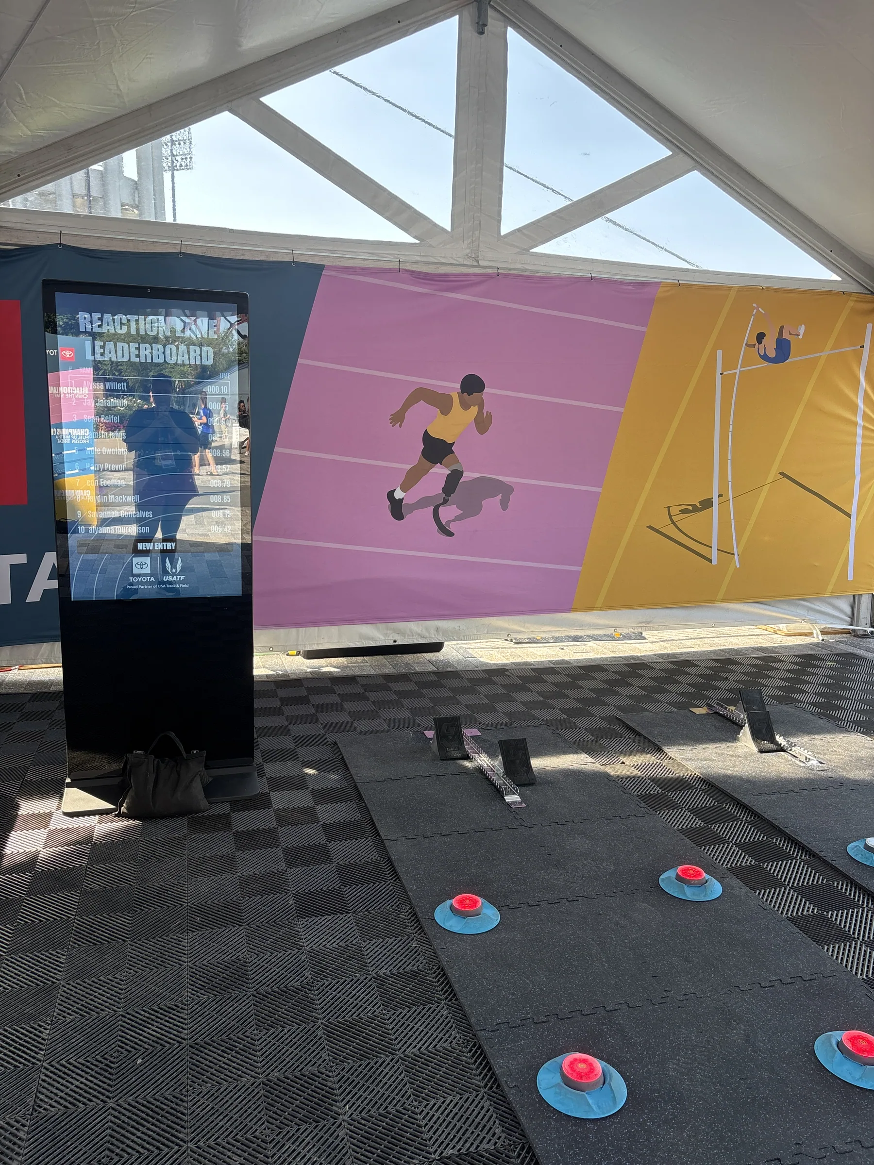 Environmental graphics wall with athlete illustrations inside the Toyota track activation