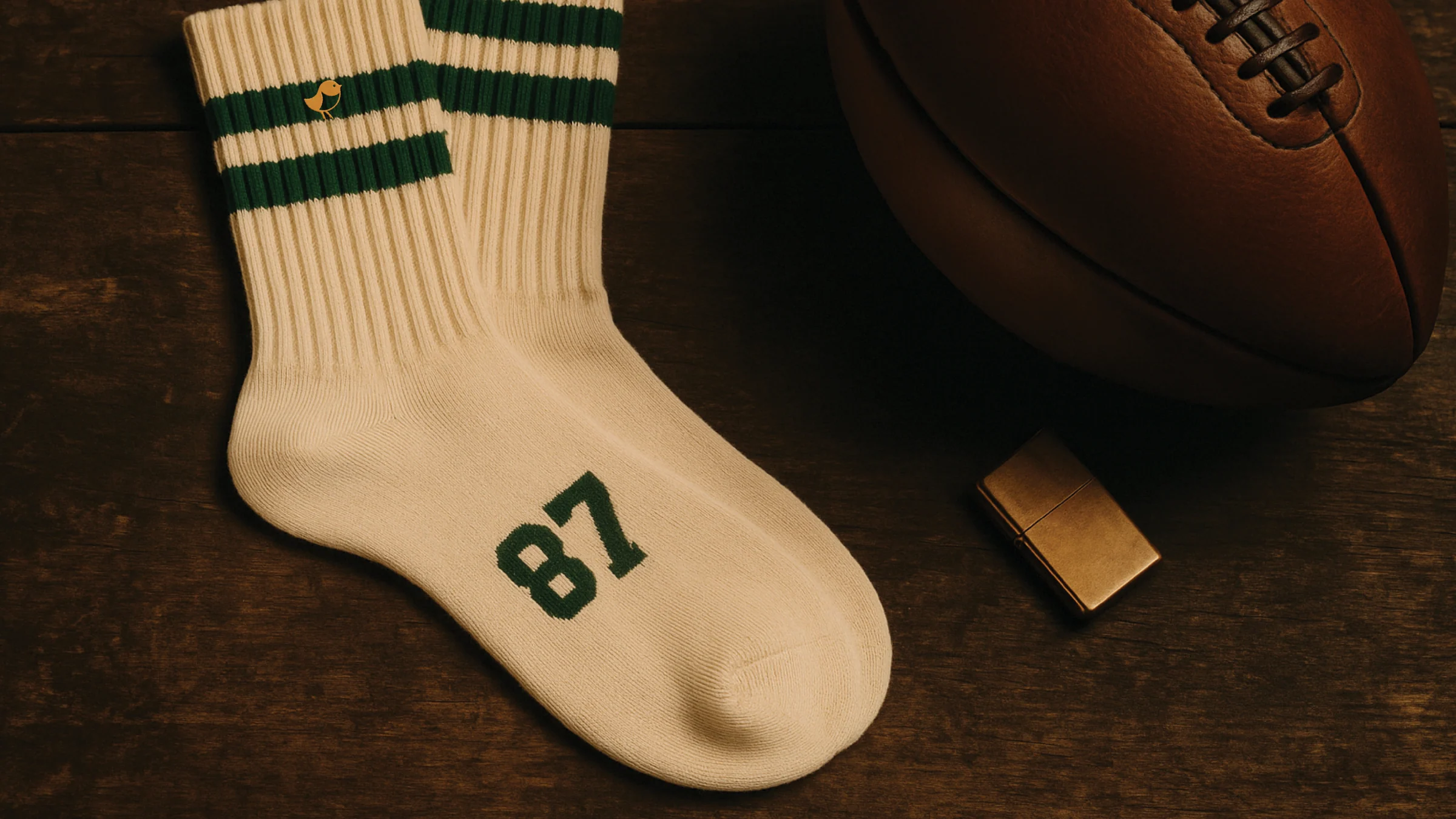 Nemacolin varsity socks styled with a leather football on a wood surface