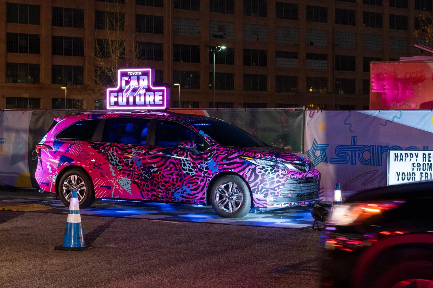 BMX rider mid-air with a lit Sienna at a neon-lit event